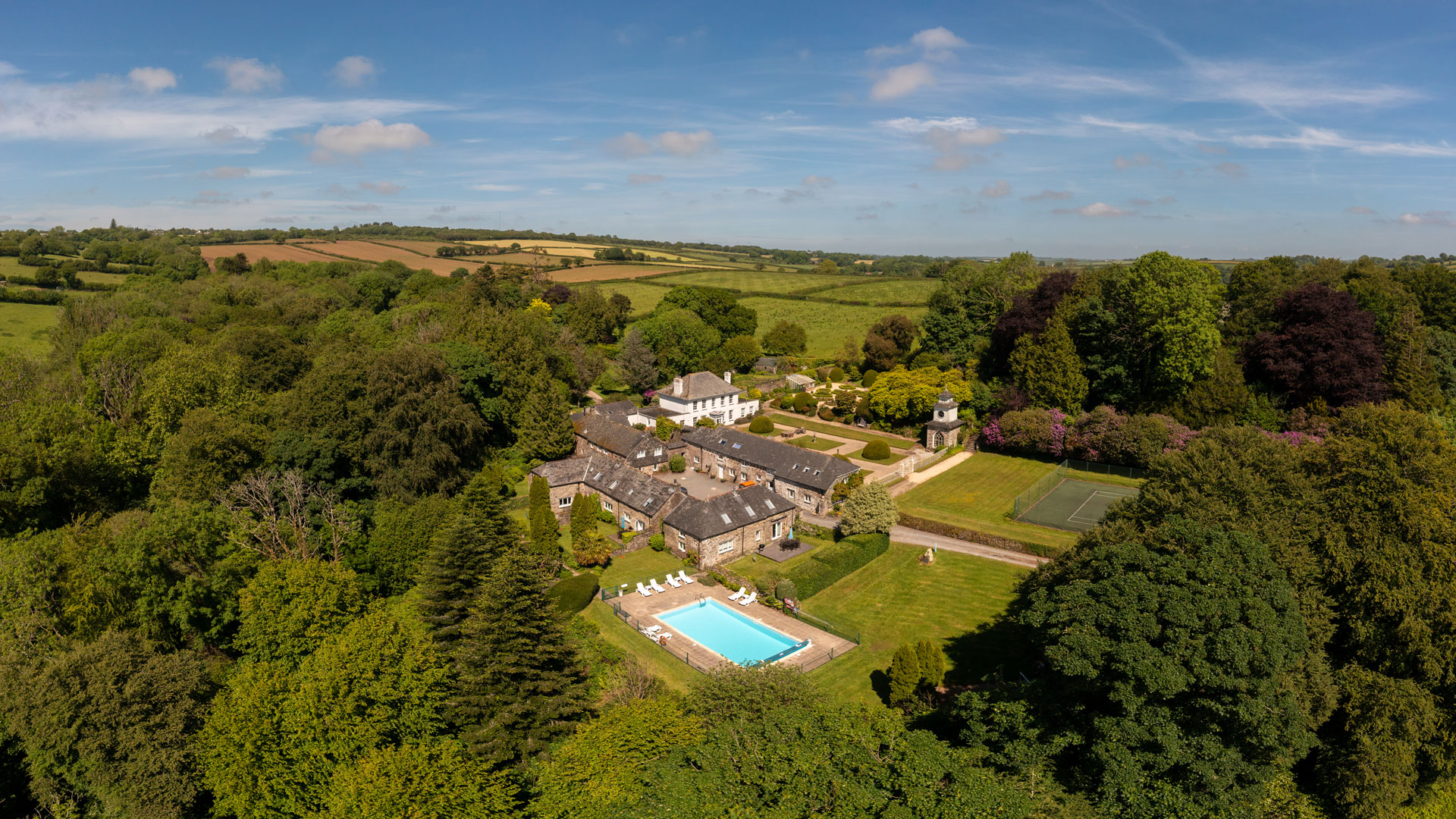 Panoramic aerial of Treworgey Manor Holiday Cottages and outdoor pool