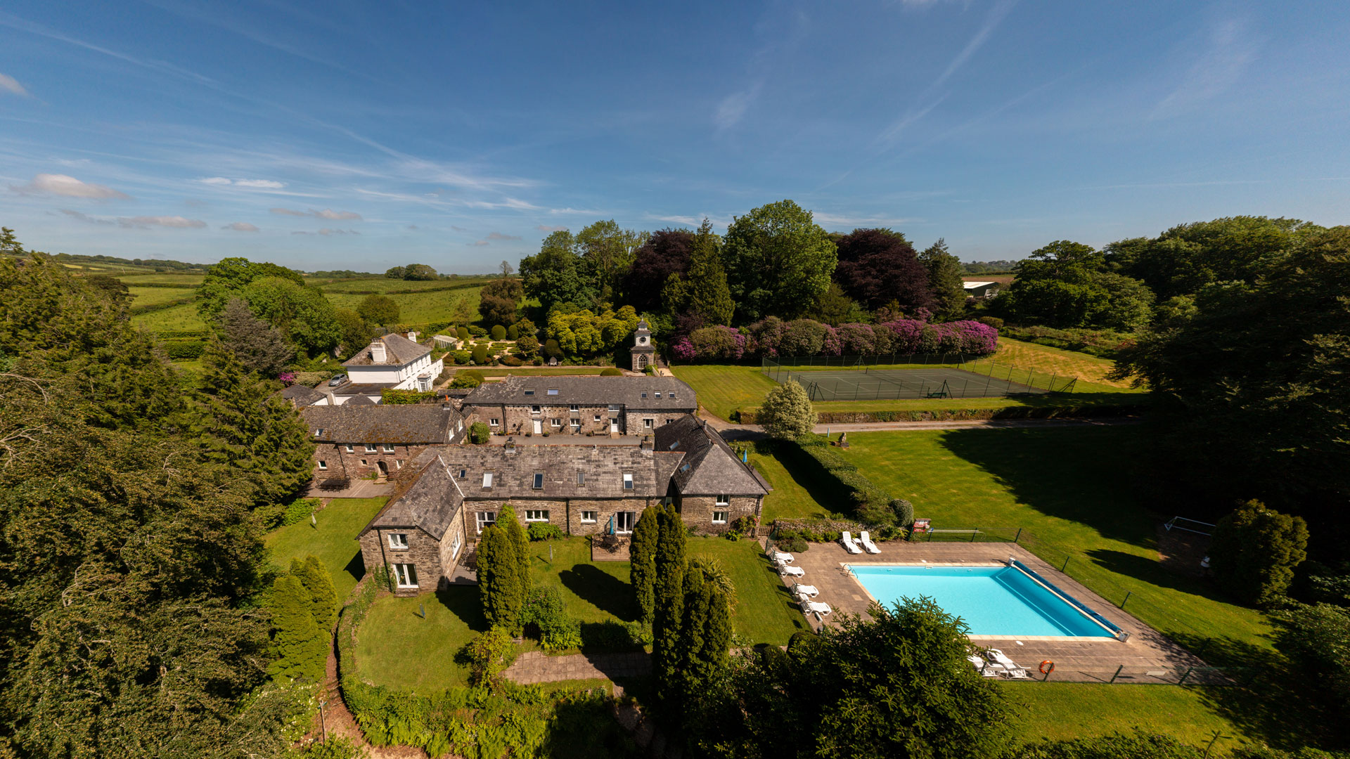 panoramic aerial of Treworgey Manor Holiday Cottages in Cornwall with outdoor heated swimming pool